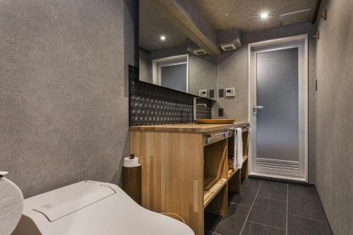a bathroom with a sink and a toilet at Shiki Homes KUMEI in Kyoto