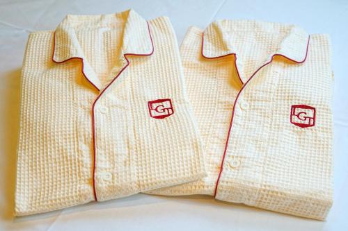 two white polo shirts are sitting next to each other at La'gent Hotel Tokyo Bay in Urayasu