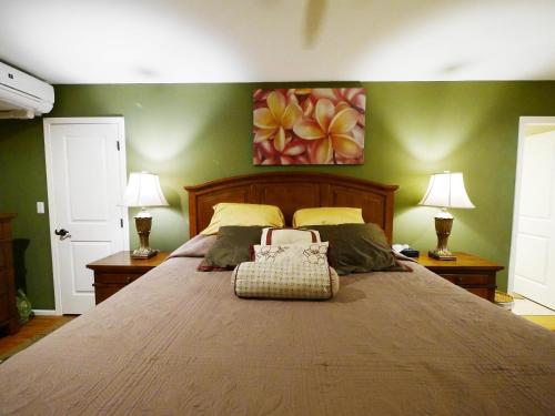 a bedroom with a large bed with two lamps at Private Vacation Villa Kohola in Motobu