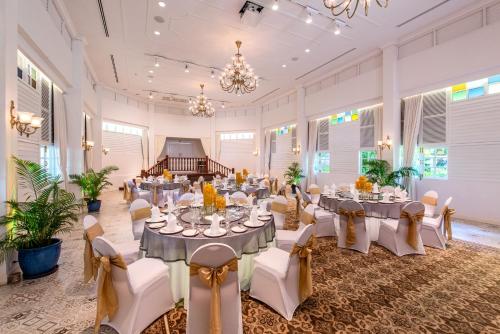 a banquet hall with tables and chairs and a piano at Sofitel Angkor Phokeethra Golf & Spa Resort in Siem Reap