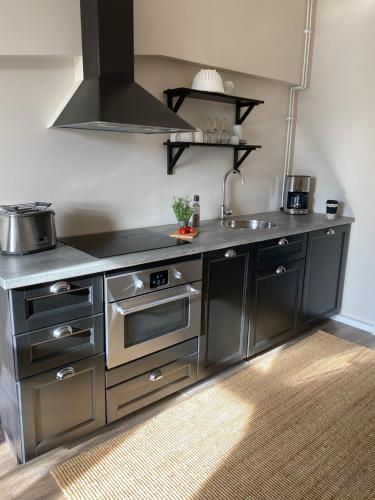 a kitchen with a stove and a sink at NO:4 in Vaasa