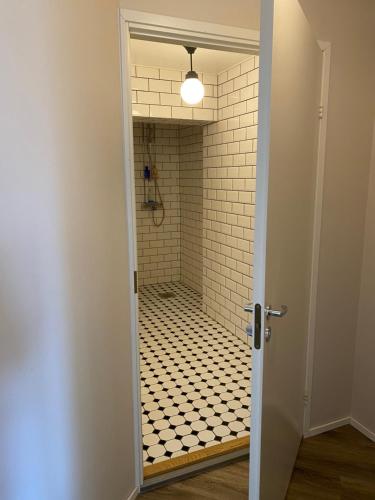 a bathroom with a shower with a black and white tile floor at NO:4 in Vaasa