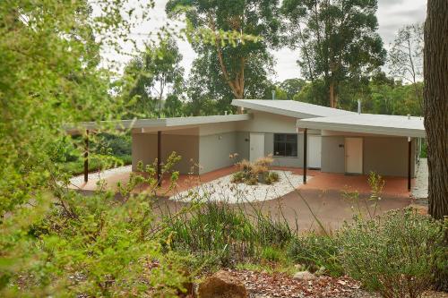 a building in the middle of a forest at Eight Willows Retreat in Margaret River Town
