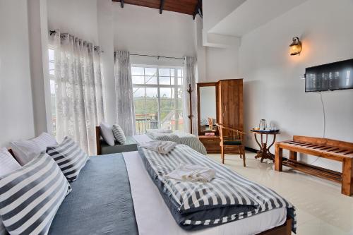 a bedroom with a bed and a living room at Misthill Rest - Lavish Villa in Nuwara Eliya