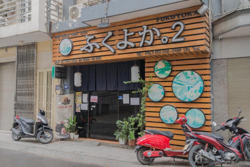 two scooters parked in front of a store at 22HOUSING 48 Phan Kế Bính in Hanoi