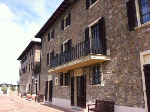 a brick building with a balcony on the side of it at Villa San Filippo in Barberino di Val dʼElsa