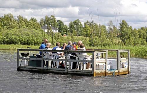 a group of people sitting on a boat in the water at Brovillan in Lekeryd