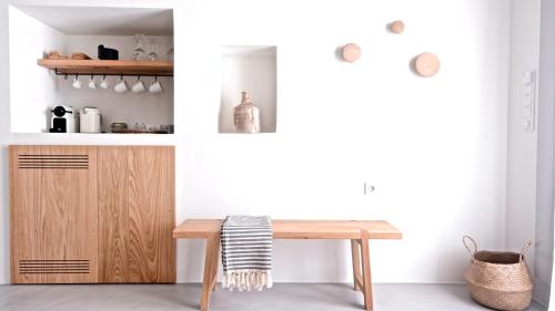 a kitchen with a wooden table and a wooden cabinet at Pénde Suites in Livadion