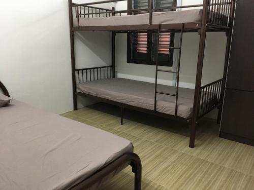 a room with two bunk beds and a bed at Homey Hostel, Ipoh Town in Ipoh