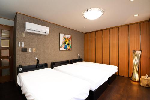 Кровать или кровати в номере Tsugumian