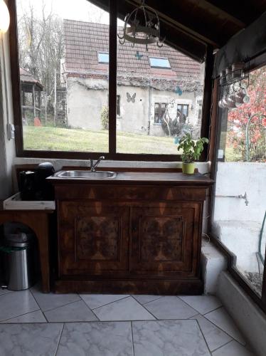 a bathroom with a wooden sink and a window at Dependance du Moulin Galuzot in Saint-Vallier