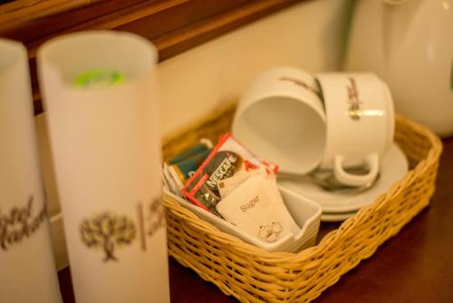 a basket with plates and a toilet on a table at Mahanuge Hotel Polonnaruwa in Polonnaruwa