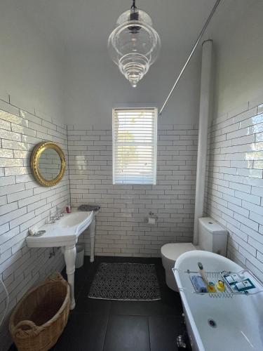 a bathroom with a sink and a tub and a toilet at Webster Terrace in Ballarat