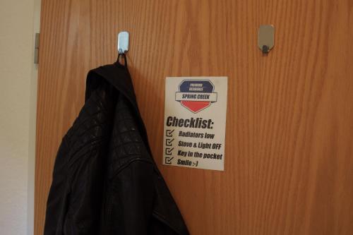 a black umbrella hanging on a door with a sign at Apartment Spring Creek in Merseburg