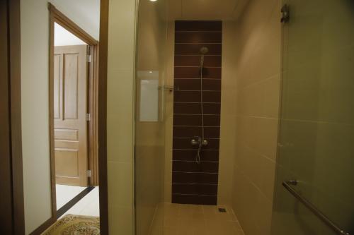 a bathroom with a shower with a glass door at Khanh Gia Apartment in Ho Chi Minh City