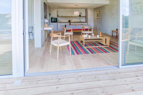 a living room with a table and a dining room at Les Terrasses de Piegu - vue mer et plage à 200 m in Pléneuf-Val-André
