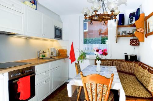 a kitchen with a table and a dining room at Ferienhaus an der Orther Reede in Fehmarn