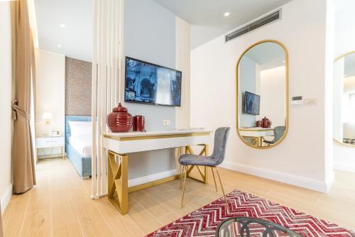 a room with a desk and a mirror at Buldero Boutique in Budva