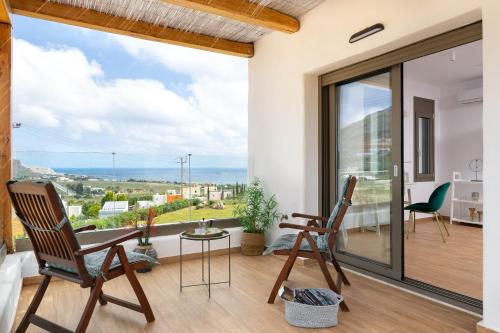 a room with two chairs and a large window at Ikaros Villa in Pefki Rhodes