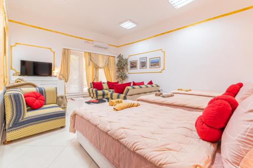 a bedroom with two beds with red pillows at Apartman 2 KOVAČINA in Nikšić