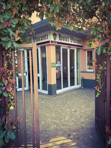 a building with a sign in front of it at Hotel Visconti in Melzo