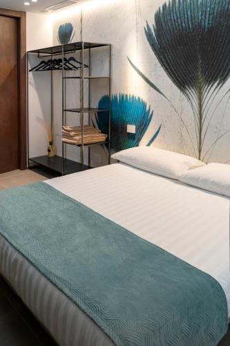 a bedroom with a large bed and a chair at La Locanda dei Cavalieri Country House in Civitanova Marche