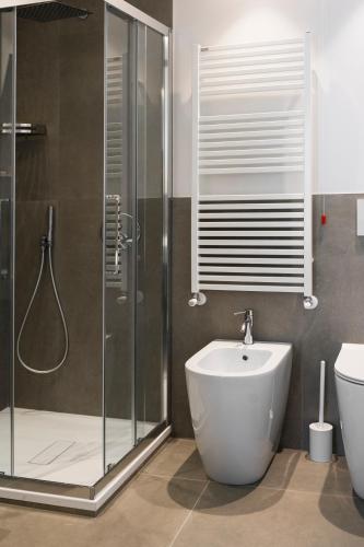 a bathroom with a shower and a sink and a toilet at La Locanda dei Cavalieri Country House in Civitanova Marche