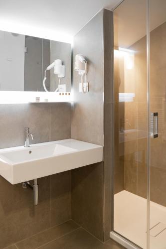 a bathroom with a sink and a shower at La Locanda dei Cavalieri Country House in Civitanova Marche