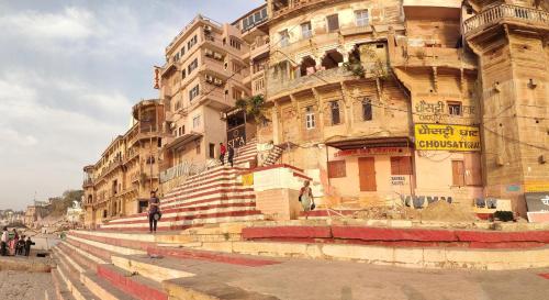 a large building with stairs in front of it at Hotel Sita Palace On Heritage Ghats Of Benaras in Varanasi