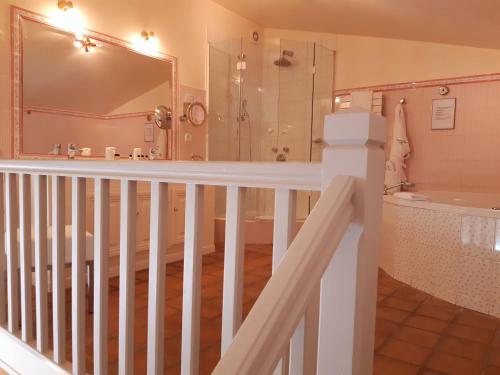 a bathroom with a tub and a sink and a shower at Auberge de Cassagne & Spa in Le Pontet