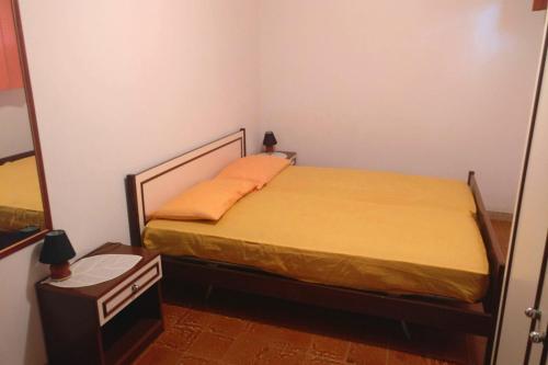 a bedroom with a bed in a room with a mirror at Villa Eulalia in Capo Vaticano