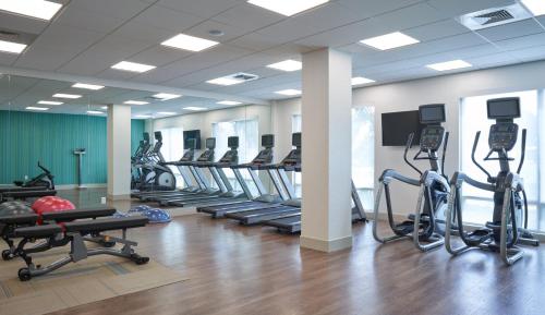 a gym with a row of treadmills and machines at Holiday Inn Express Doral Miami by IHG in Doral