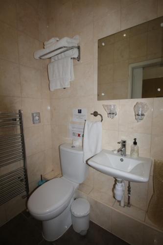 a bathroom with a toilet and a sink at Tennyson in Lincoln