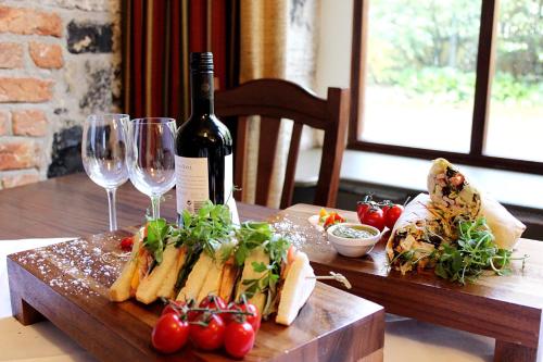 a table with a bottle of wine and a plate of food at Abbey Court in Nenagh