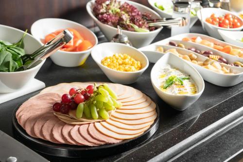 a table topped with different types of food on a table at Landmark Hotel & Suites فندق وأجنحة لاندمارك in Jeddah