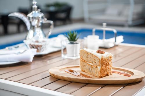 a piece of cake on a plate on a counter at Landmark Hotel & Suites فندق وأجنحة لاندمارك in Jeddah