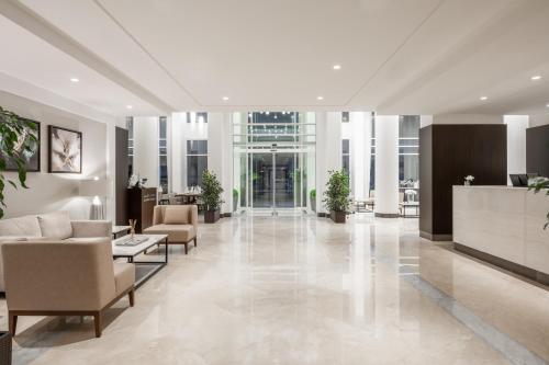 a lobby with couches and chairs and a reception desk at Landmark Hotel & Suites فندق وأجنحة لاندمارك in Jeddah