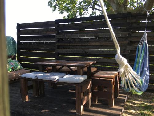a picnic table and chairs and an umbrella at HERDADE PALMA t2 in Moita