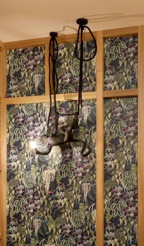a window with a curtain with flowers on it at Goldengel Design - Suiten im historischen Ortskern von Kaltern in Caldaro