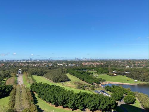 an aerial view of a park with a river and trees at Parkside & City view in Sydney Olympic Park in Sydney