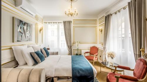a bedroom with a large bed and a chandelier at Luxury 6 Bedroom 5 bathroom Palace Apartment - Louvre View in Paris