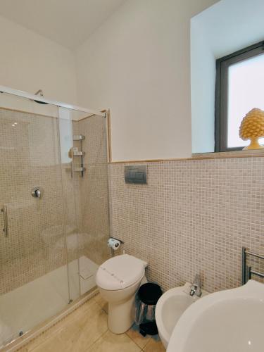 a bathroom with a shower and a toilet and a sink at Il Meraviglioso Mondo di Amélie in Agrigento