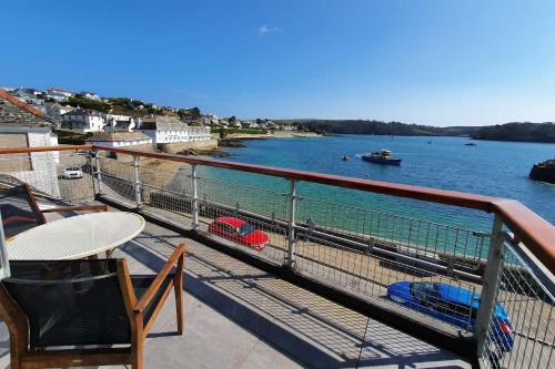 
a view from a balcony of a harbor with boats docked at Careema in Saint Mawes
