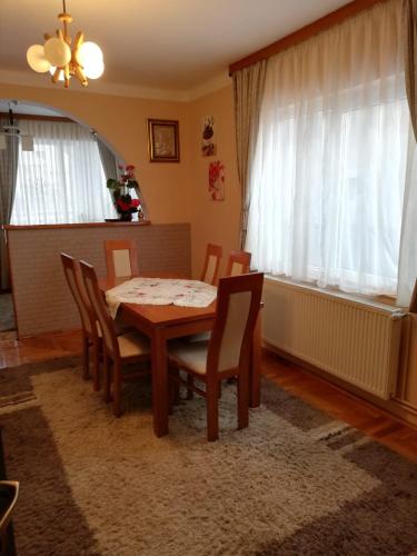 a dining room with a table and chairs at Pensiunea Denisa Stoian in Moieciu de Jos