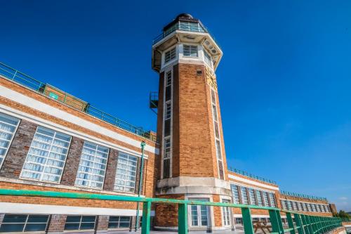 a brick building with a clock tower on top at Crowne Plaza Liverpool - John Lennon Airport by IHG in Liverpool