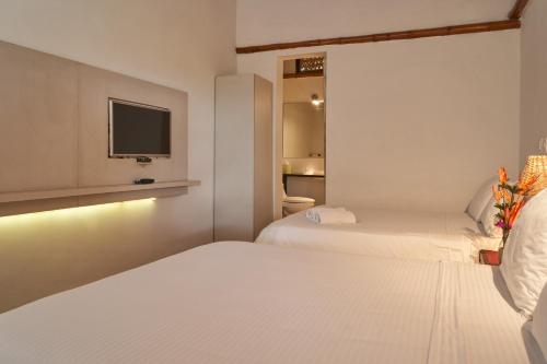 Ένα ή περισσότερα κρεβάτια σε δωμάτιο στο Hotel Hacienda Combia