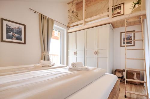 a bedroom with a bunk bed and a ladder at die Tauplitz Lodges - Mountain view Lodge A11 by AA Holiday Homes in Tauplitz