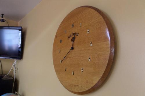 a wooden clock hanging on a wall at Lynchburg Country Inn in Lynchburg