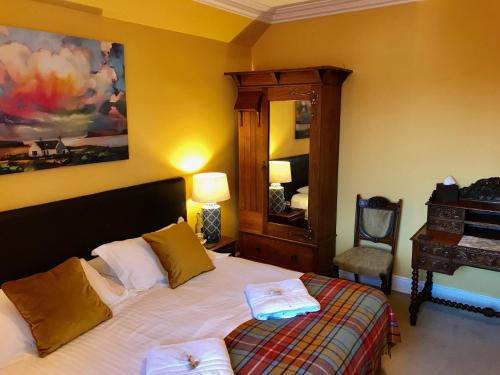 a bedroom with a bed and a mirror at Lairds Lodge Inverness in Inverness