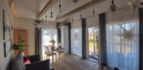 a living room with a couch and a table at Brīvdienu māja ar Saunu in Saulkrasti